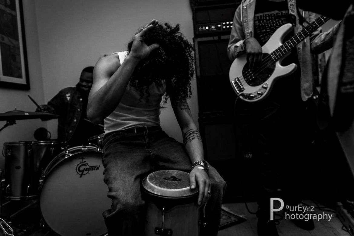 black & white photo of Antony playing hand drums